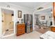 Open-concept kitchen with stainless steel refrigerator flowing into a living space with a fireplace and hardwood floors at 409 Trail Two, Burlington, NC 27215