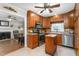 Well-equipped kitchen with warm wooden cabinetry, stainless steel appliances, and an island at 409 Trail Two, Burlington, NC 27215