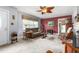 Cozy living room with plush carpeting, vintage-inspired furniture, and decorative ceiling fan at 409 Trail Two, Burlington, NC 27215