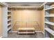 Spacious walk-in closet featuring ample shelving, hanging rods and a convenient storage bench at 409 Trail Two, Burlington, NC 27215