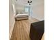 Inviting bedroom with a ceiling fan, wood-look flooring, and a view of the closet at 41 Lakewood Dr, Roxboro, NC 27573