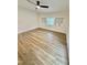 Bright bedroom featuring wood-look floors, large window, white walls, and a ceiling fan at 41 Lakewood Dr, Roxboro, NC 27573