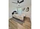 Cozy bedroom with modern fan, plush bedding, and stylish abstract art at 41 Lakewood Dr, Roxboro, NC 27573