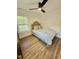 Comfortable bedroom with a plush comforter, warm wooden floors, and ample light at 41 Lakewood Dr, Roxboro, NC 27573