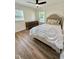Comfortable bedroom with a plush comforter, warm wooden floors, and ample light at 41 Lakewood Dr, Roxboro, NC 27573