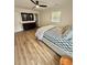Comfortable bedroom with light walls, wood-look flooring, and ample natural light at 41 Lakewood Dr, Roxboro, NC 27573