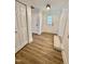 Inviting entryway featuring wood-look floors, white trim, and closet space at 41 Lakewood Dr, Roxboro, NC 27573