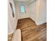 Inviting entryway featuring wood-look floors, white trim, and closet space at 41 Lakewood Dr, Roxboro, NC 27573