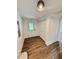 Inviting entryway featuring wood-look floors, white trim, and closet space at 41 Lakewood Dr, Roxboro, NC 27573