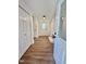 Inviting entryway featuring wood-look floors, white trim, and closet space at 41 Lakewood Dr, Roxboro, NC 27573