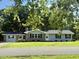 Charming single story home featuring a manicured lawn, brick accents, and black shutters at 41 Lakewood Dr, Roxboro, NC 27573
