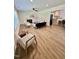 Open-concept living room with wood floors, recessed lighting, fireplace, and an adjacent kitchen at 41 Lakewood Dr, Roxboro, NC 27573