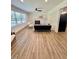 Spacious living room featuring wood floors, recessed lighting, a fireplace, and a large window at 41 Lakewood Dr, Roxboro, NC 27573