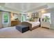 A spacious bedroom featuring a tray ceiling, neutral decor, and plentiful natural light at 4106 Sweet Ivy Lndg # 179, Durham, NC 27703