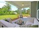 Relaxing covered porch with comfortable outdoor furniture and views of the scenic backyard at 4106 Sweet Ivy Lndg # 179, Durham, NC 27703