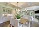 Dining room with hardwood flooring and view to the living room with fireplace at 4106 Sweet Ivy Lndg # 179, Durham, NC 27703