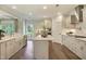 A bright kitchen features a central island, stainless steel appliances, and hardwood floors at 4106 Sweet Ivy Lndg # 179, Durham, NC 27703