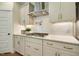 A gourmet kitchen features quartz countertops, subway tile backsplash, and stainless steel appliances at 4106 Sweet Ivy Lndg # 179, Durham, NC 27703
