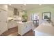 A bright kitchen features a central island, stainless steel appliances, and hardwood floors at 4106 Sweet Ivy Lndg # 179, Durham, NC 27703