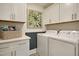 A well-organized laundry room features ample storage space, neutral decor, and modern appliances at 4106 Sweet Ivy Lndg # 179, Durham, NC 27703