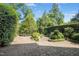 Paver stone patio and lush landscaping create a serene and private backyard retreat at 4137 Gardenlake Dr, Raleigh, NC 27612