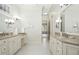 Elegant bathroom with dual vanities featuring granite countertops and decorative lighting at 4137 Gardenlake Dr, Raleigh, NC 27612