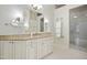 Luxurious bathroom featuring custom cabinetry, granite countertops, and a seamless glass shower at 4137 Gardenlake Dr, Raleigh, NC 27612