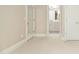 Neutral bedroom with ensuite bathroom features neutral carpet, white trim and baseboard, and white doors at 4137 Gardenlake Dr, Raleigh, NC 27612