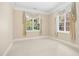 Sunny bedroom with two large windows with decorative curtains, neutral carpet, and clean white trim at 4137 Gardenlake Dr, Raleigh, NC 27612