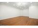 Unfurnished room features hardwood floors, modern light fixture, and recessed lighting, perfect for customization at 4137 Gardenlake Dr, Raleigh, NC 27612