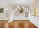 Open dining room with classic decor, chandelier, and seamless access to kitchen area at 4137 Gardenlake Dr, Raleigh, NC 27612