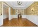 Spacious dining area with elegant chandelier, decorative wallpaper, and views into kitchen at 4137 Gardenlake Dr, Raleigh, NC 27612