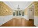 Charming dining room with decorative wallpaper, wainscoting, and large windows for natural light at 4137 Gardenlake Dr, Raleigh, NC 27612