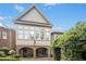 Beautiful exterior elevation showcases a home with brick arches, complemented by lush landscaping and mature trees at 4137 Gardenlake Dr, Raleigh, NC 27612