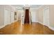 Bright foyer boasts hardwood floors, staircase with red carpet, and multiple doors with classic trim at 4137 Gardenlake Dr, Raleigh, NC 27612