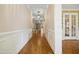 Elegant hallway with detailed molding, hardwood floors, and stylish lighting fixtures at 4137 Gardenlake Dr, Raleigh, NC 27612