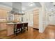 Bright kitchen features stainless hood vent, two-tone cabinets, granite counters, hardwood floors, and seating for two at 4137 Gardenlake Dr, Raleigh, NC 27612