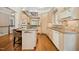 Open kitchen shows stainless appliances, recessed lighting, two-tone cabinets, hardwood floors, and granite counters at 4137 Gardenlake Dr, Raleigh, NC 27612