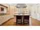 Kitchen area shows stainless hood vent, recessed lighting, two-tone cabinets, hardwood floors, and granite counters at 4137 Gardenlake Dr, Raleigh, NC 27612