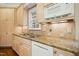 Kitchen features under cabinet lighting, stainless sink, dishwasher, two-tone cabinets, and granite counters at 4137 Gardenlake Dr, Raleigh, NC 27612