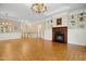 Spacious living room features a fireplace, hardwood floors, chandelier, custom built-in cabinets, and staircase at 4137 Gardenlake Dr, Raleigh, NC 27612