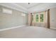 The main bedroom features wallpaper, large window with curtains and carpeted floors at 4137 Gardenlake Dr, Raleigh, NC 27612
