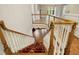 Grand staircase with wooden banisters and a patterned carpet runner at 4137 Gardenlake Dr, Raleigh, NC 27612