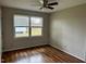 A bright bedroom with hardwood floors, a ceiling fan, and double windows bringing in natural light at 424 Shawnee Dr, Louisburg, NC 27549