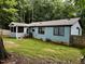 Rear exterior view of the home, with access to screened-in porch, surrounded by a fenced yard at 424 Shawnee Dr, Louisburg, NC 27549