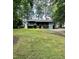 Single-story home with a spacious front yard and long driveway at 424 Shawnee Dr, Louisburg, NC 27549