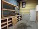 A workshop area inside the garage with a workbench, wood shelving, and plenty of natural light at 424 Shawnee Dr, Louisburg, NC 27549
