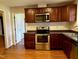 Updated kitchen featuring stainless steel oven, dishwasher, and hard wood floors at 424 Shawnee Dr, Louisburg, NC 27549