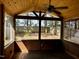 View from screened-in porch with wood-paneled ceiling overlooking the backyard, beautiful at 424 Shawnee Dr, Louisburg, NC 27549