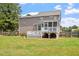Lovely backyard showcasing a spacious lawn, deck and screened-in porch at 44 Clarke Ct, Angier, NC 27592